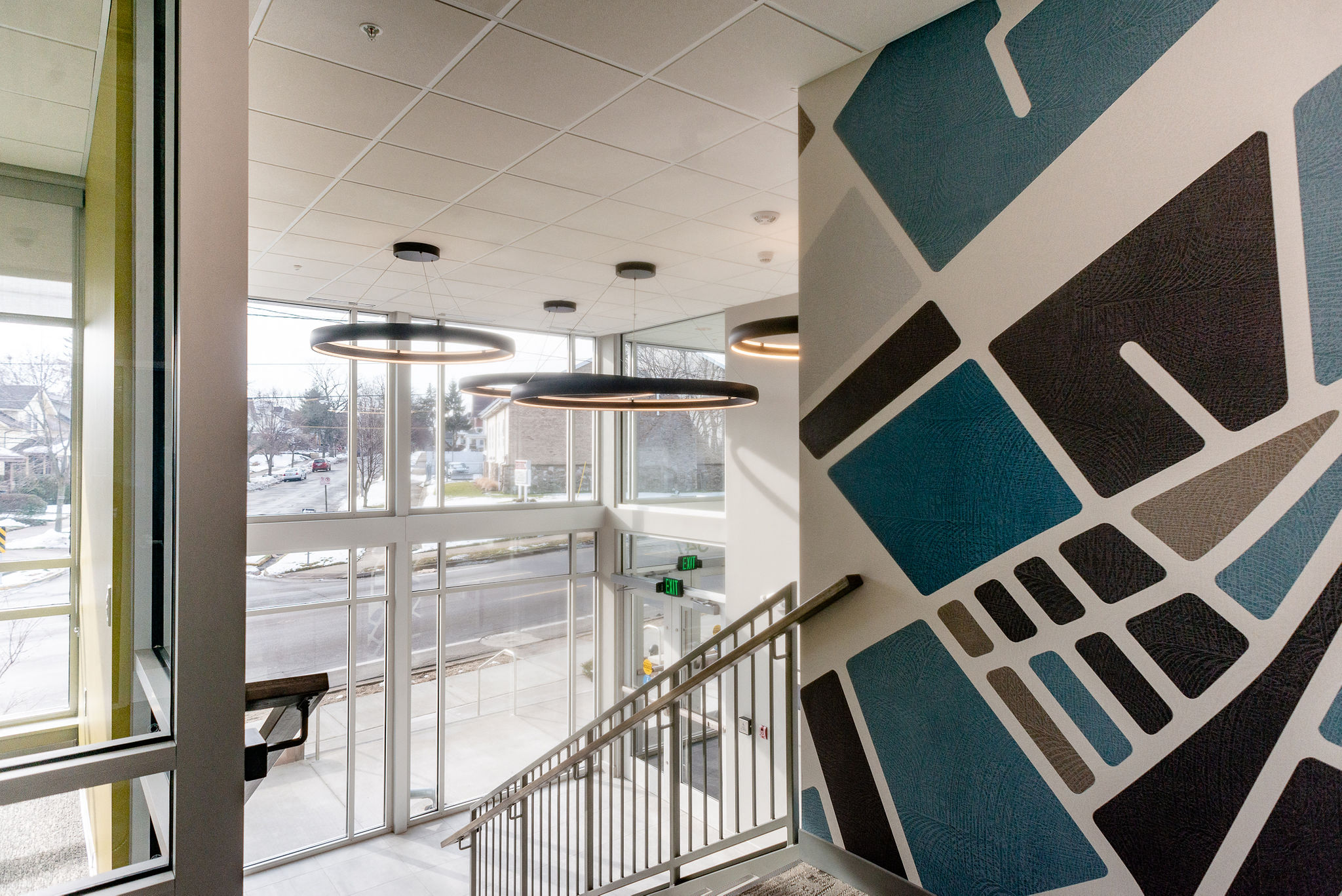 Entrance with glass walls and modern light fixtures